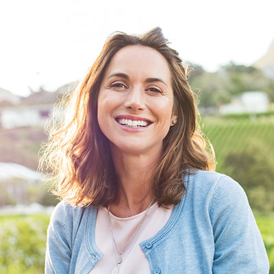 Happy woman outside looking at the camera