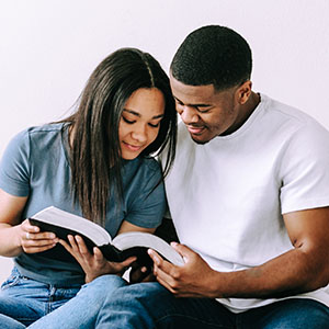 Couple sitting down looking at a Bible. I want to explore the Bible